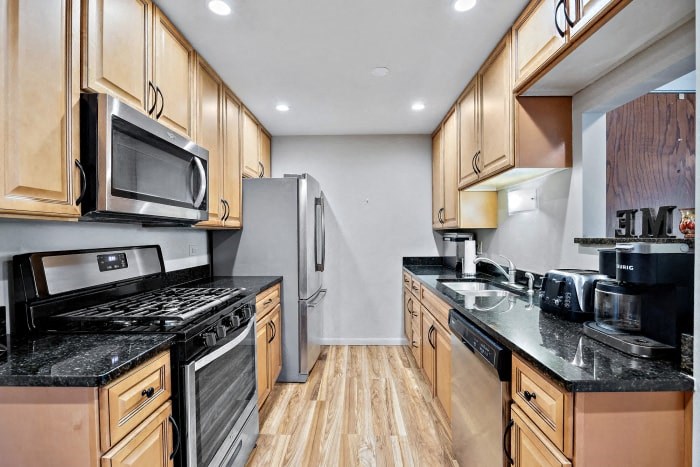 a kitchen with stainless steel appliances and wooden cabinets