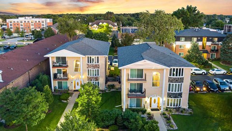 an aerial view of an apartment complex at sunset