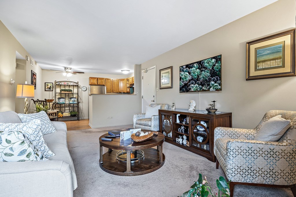 a living room with couches and chairs and a table