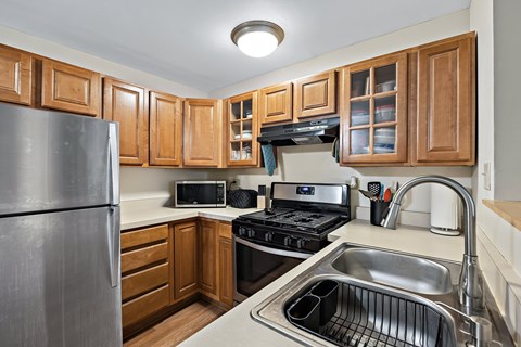 A kitchen with wooden cabinets and stainless steel appliances.