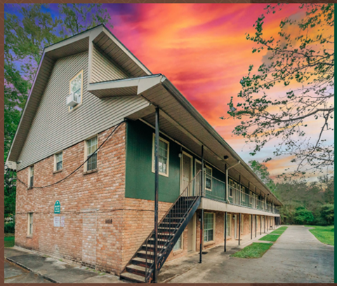 an image of a building with a sunset behind it