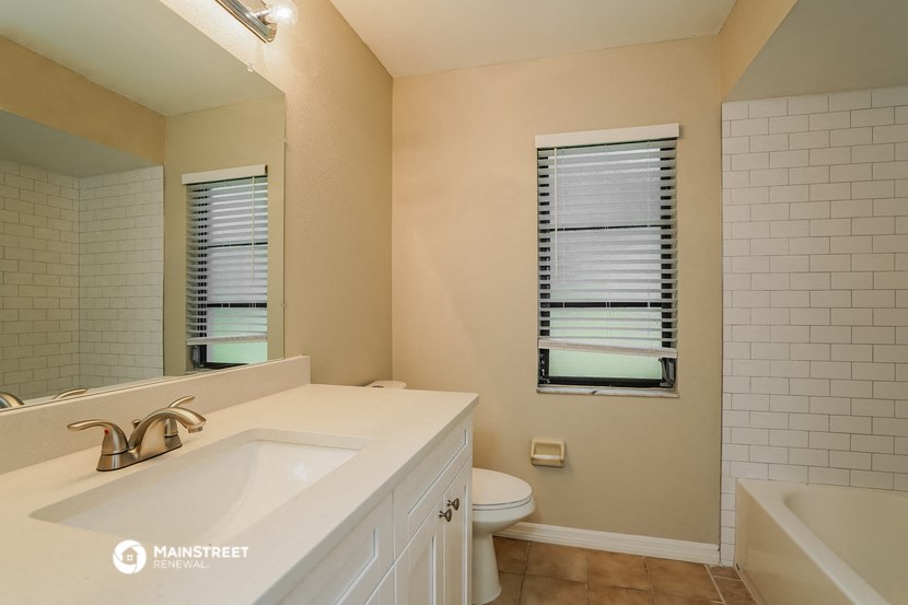 a bathroom with a sink and a toilet and a mirror