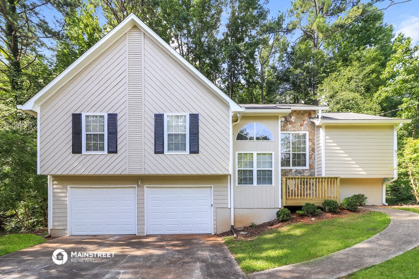 a white house with black shutters and a driveway