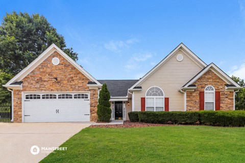 a house with a green lawn and a white garage door