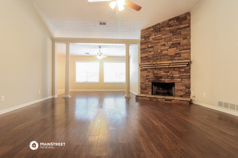 the living room with fireplace and hardwood floors
