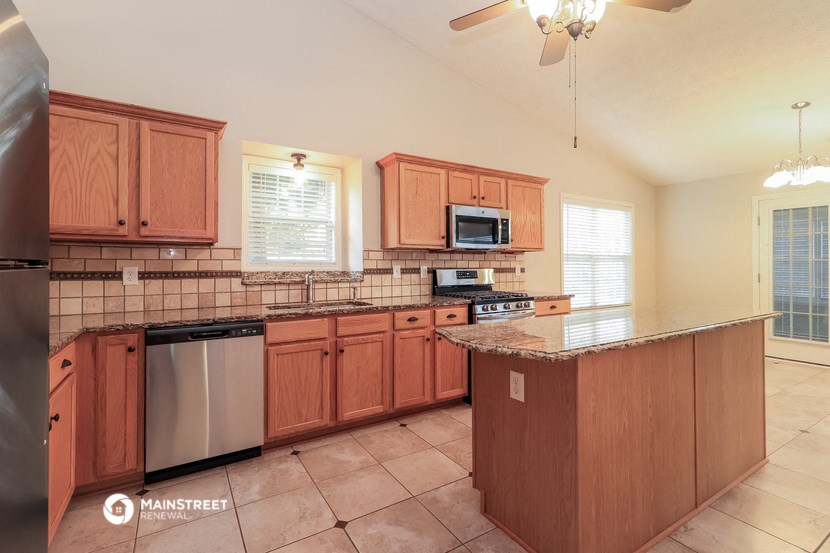 a kitchen with wooden cabinets and a counter top