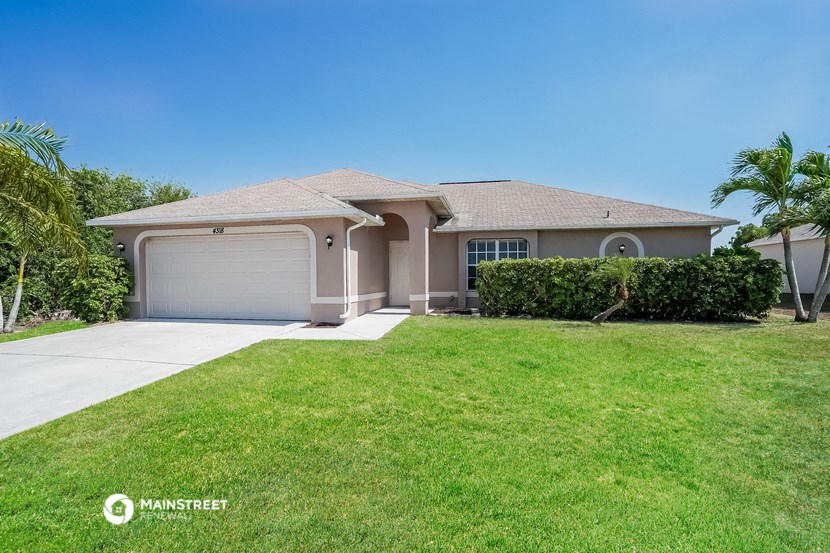 a house with a lawn and a driveway