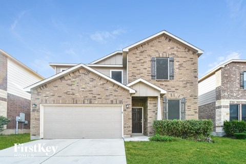 a brick house with a garage door in front of it