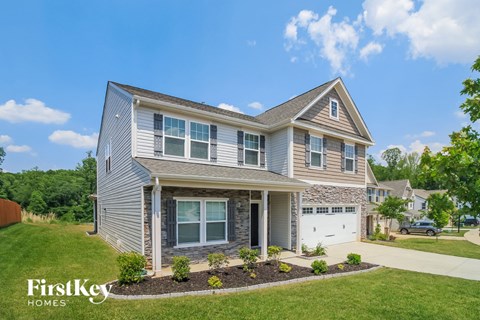 A two-story house with a garage is for sale by FirstKey Homes.