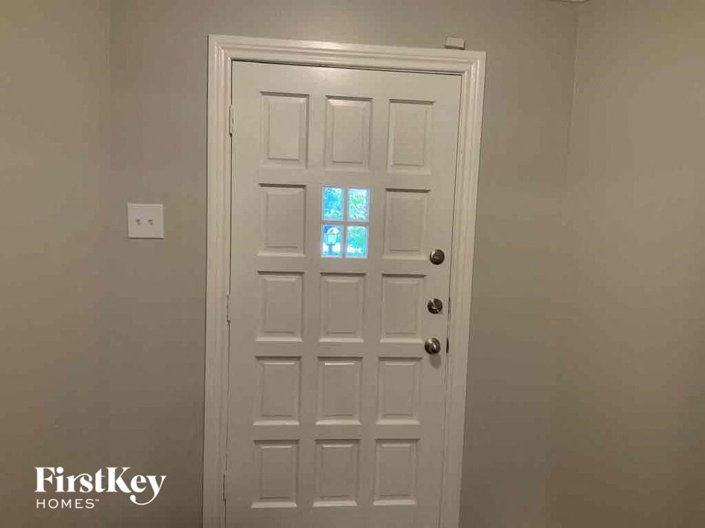 a window on a white door in a white room