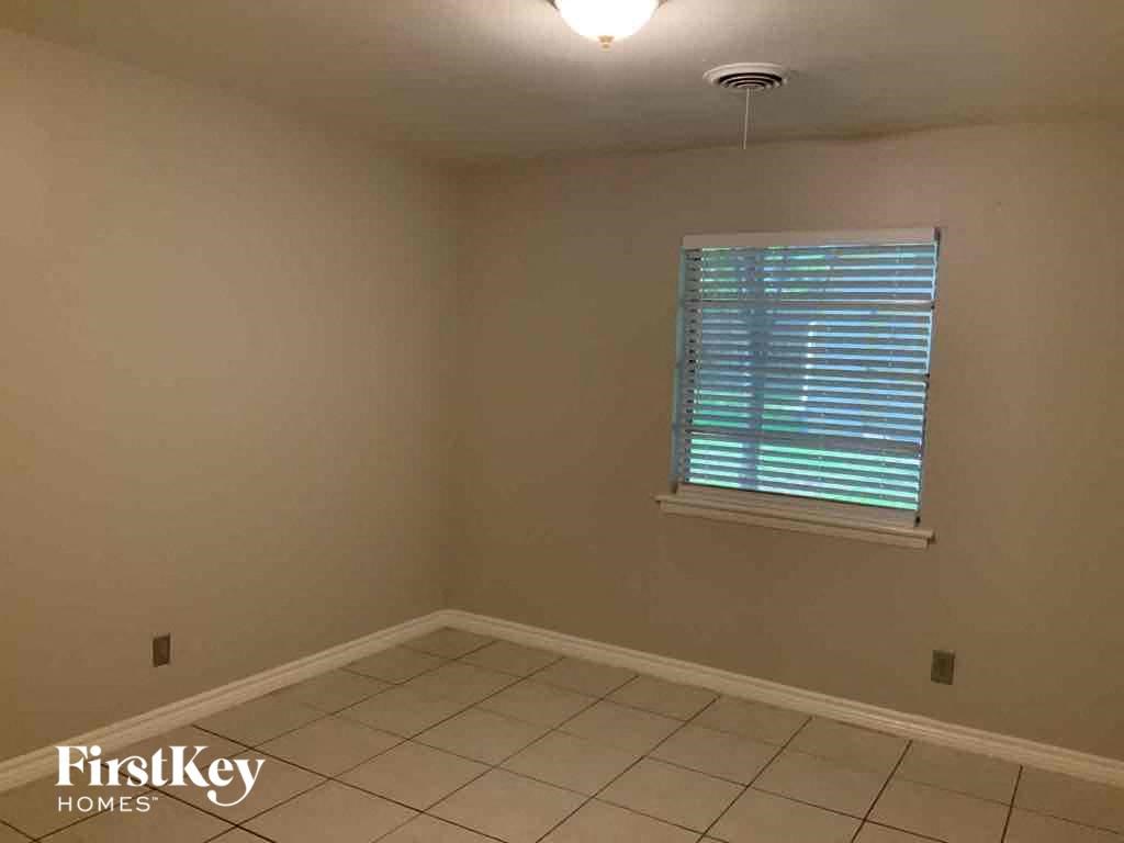 a room with a window and a tiled floor