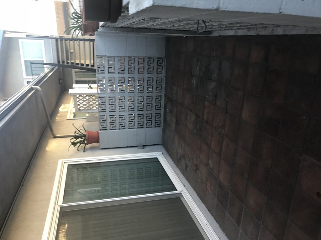 A small window with a view of a building outside.