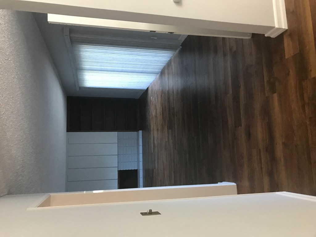 A white sink in a bathroom with wooden walls.