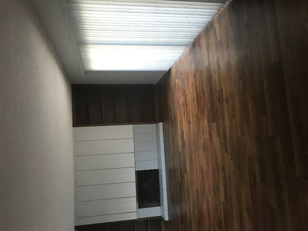 A white shelf with a black box on it.