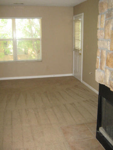 a living room with a fireplace and a wooden floor