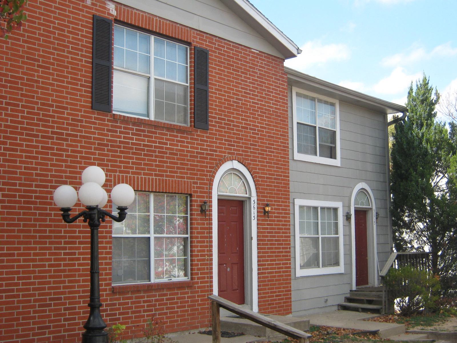 the side of a brick building with a red door
