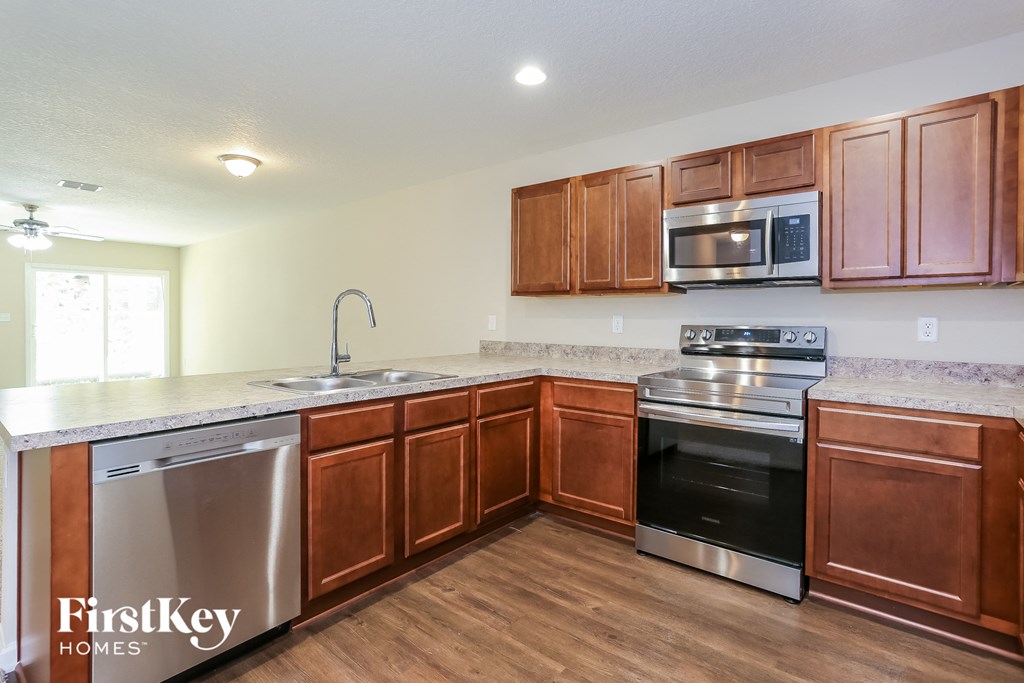 a kitchen with wooden cabinets and stainless steel appliances