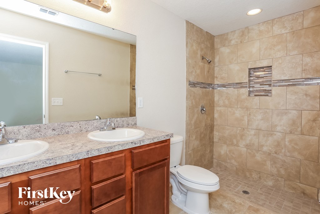 a bathroom with a toilet and a sink and a shower
