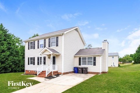 A house with a white exterior and a small porch.