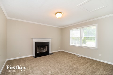 A room with a fireplace and a window.
