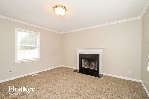 A room with a fireplace and a window.