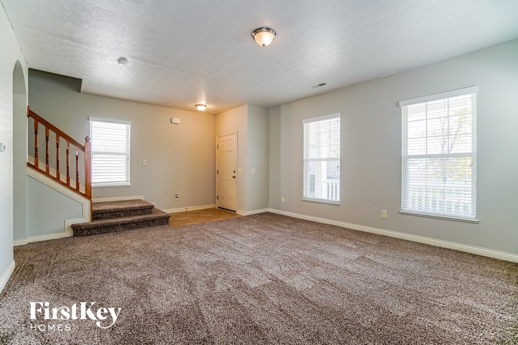 the living room and entryway of an empty house