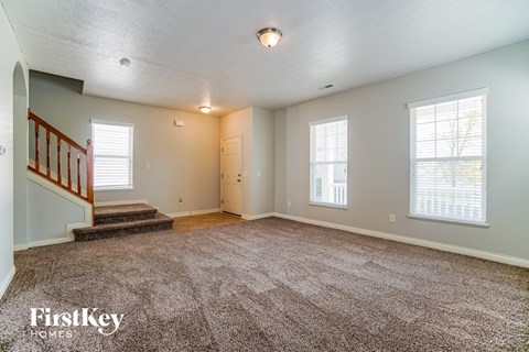 the living room and entryway of an empty house