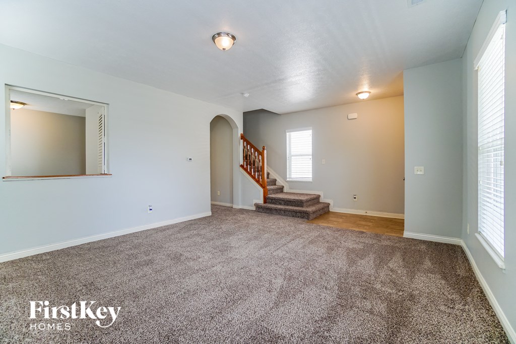 the living room and entryway of an empty house