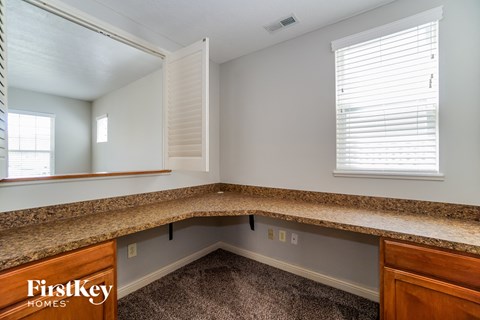 a kitchen with a granite counter top and a large mirror
