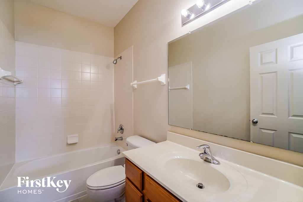 a bathroom with a sink and a toilet and a tub