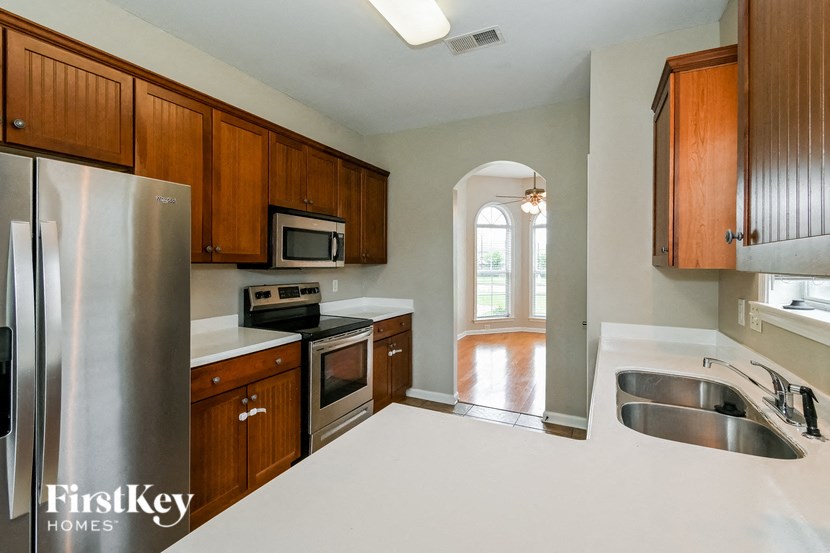 a kitchen with wooden cabinets and stainless steel appliances