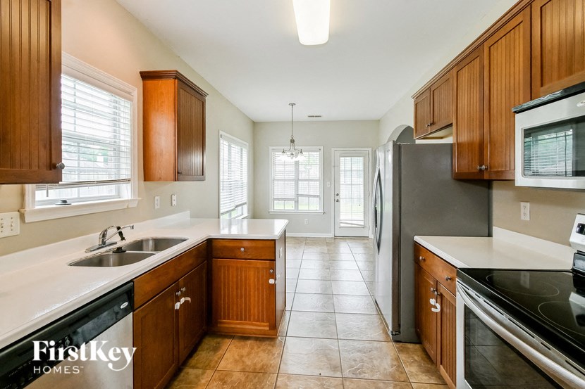 a kitchen with wooden cabinets and stainless steel appliances