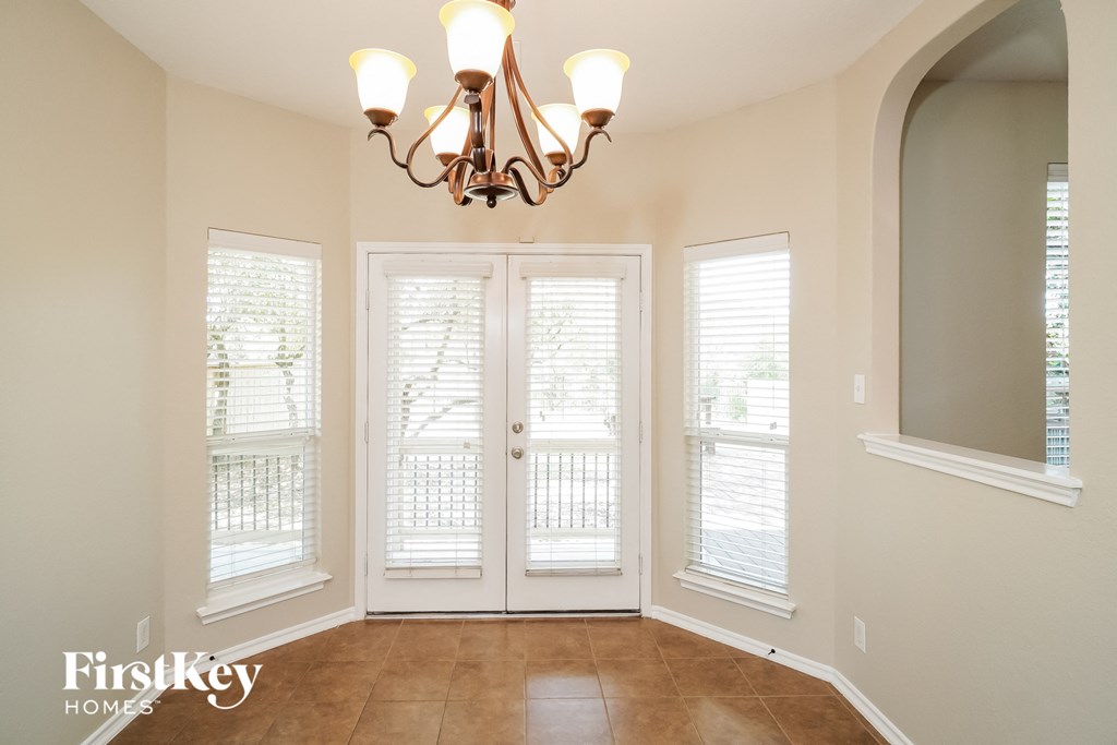 a dining room doors and a chandelier