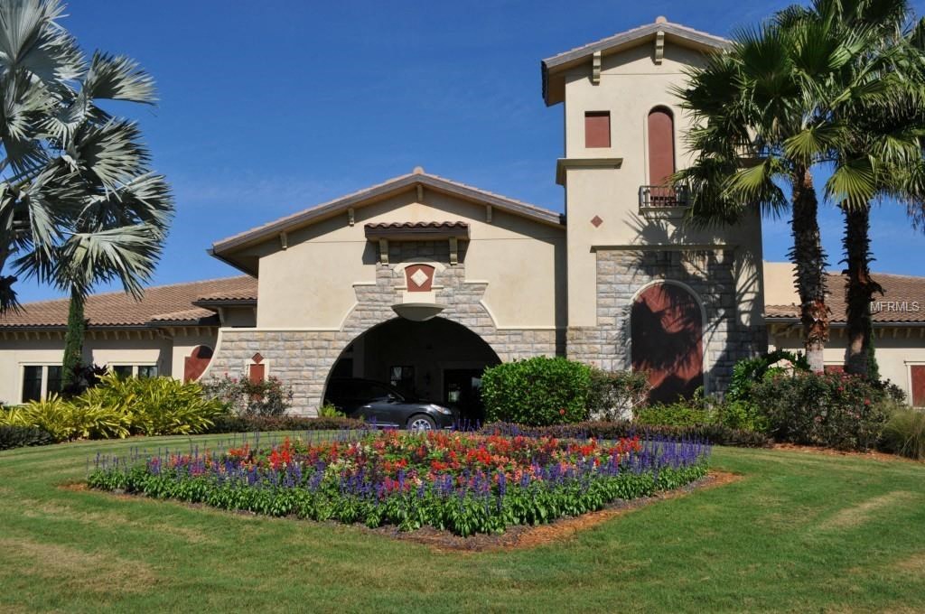 A building with a red cross on the front and a car parked in front.