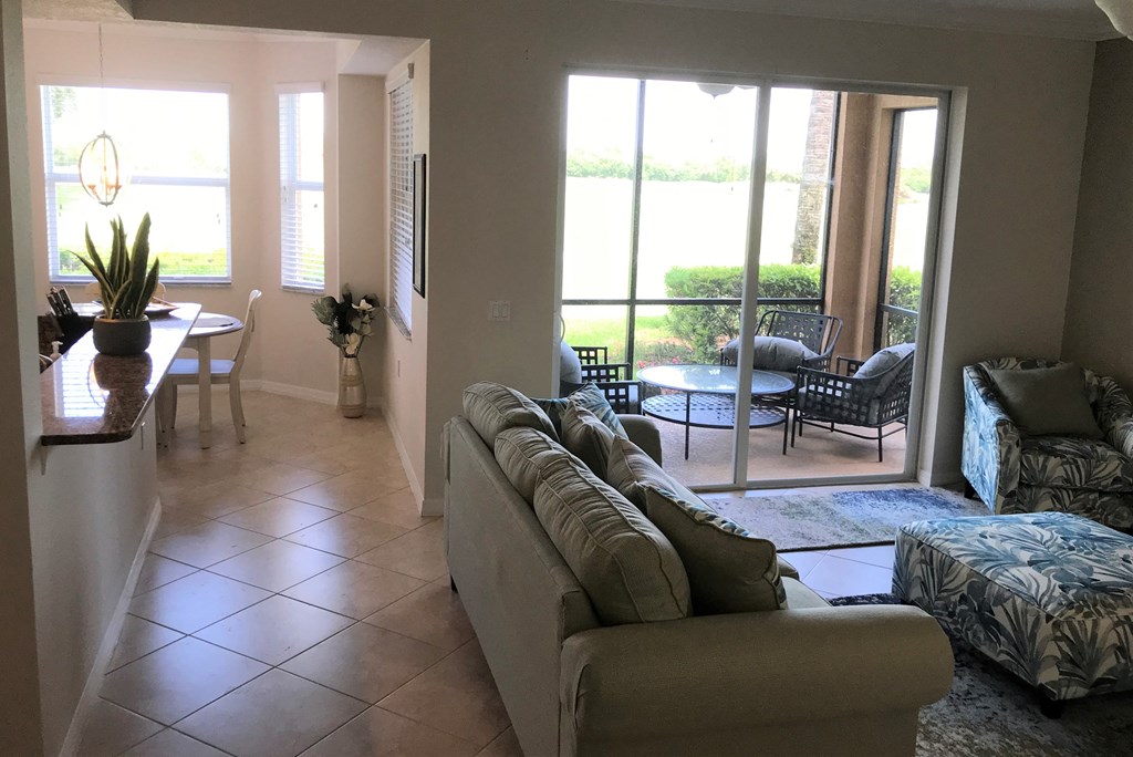 A living room with a couch and a dining table.