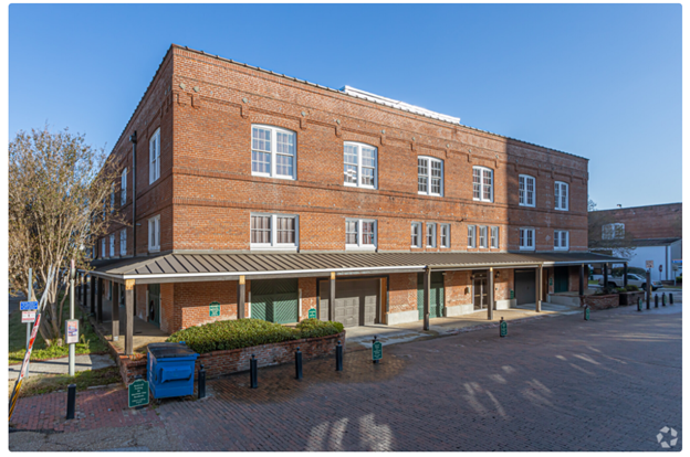 a large brick building on the corner of a street