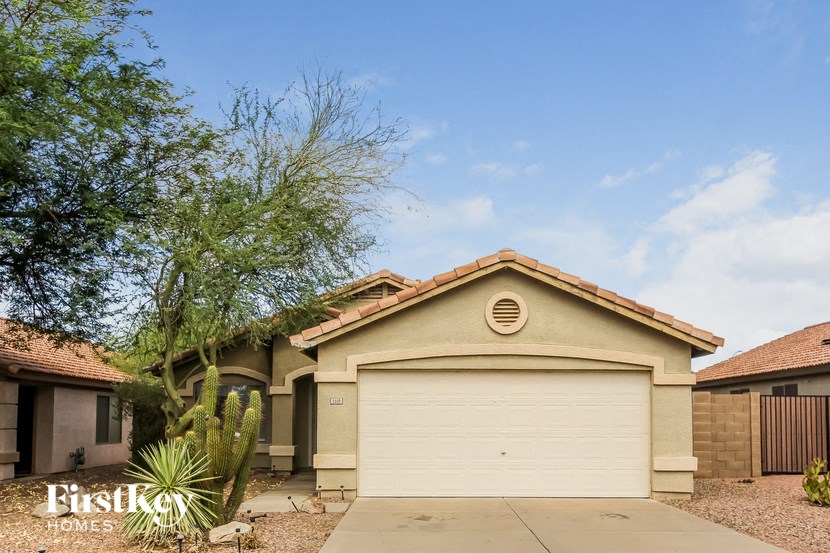 a house with a garage and a tree in front of it