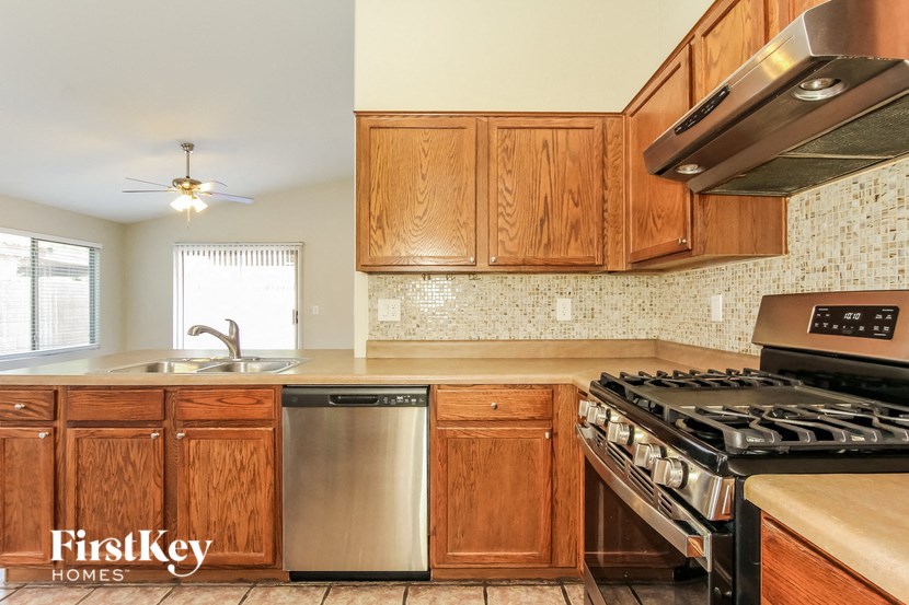 a kitchen with wooden cabinets and stainless steel appliances