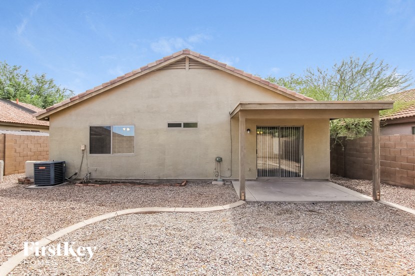 a small house with a driveway and a garage door