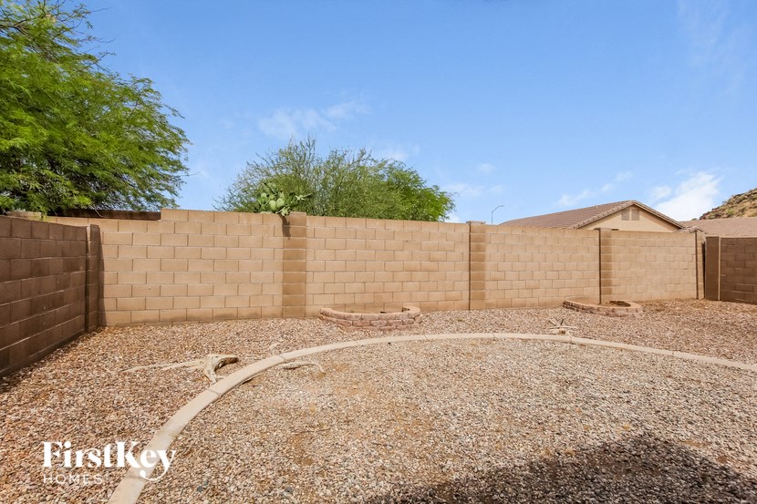 a retaining wall in a backyard with gravel
