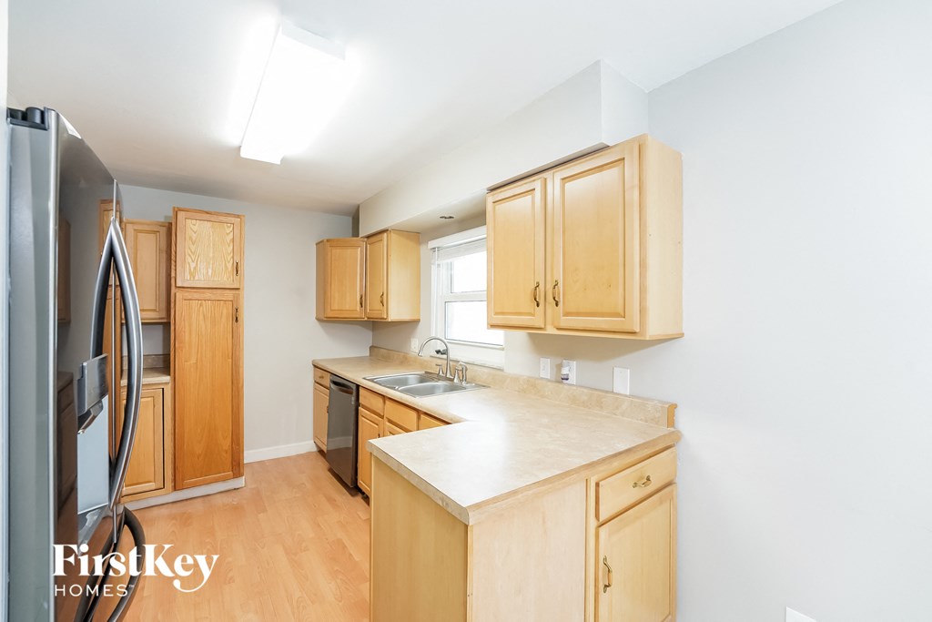 a kitchen with wooden cabinets and a white counter top