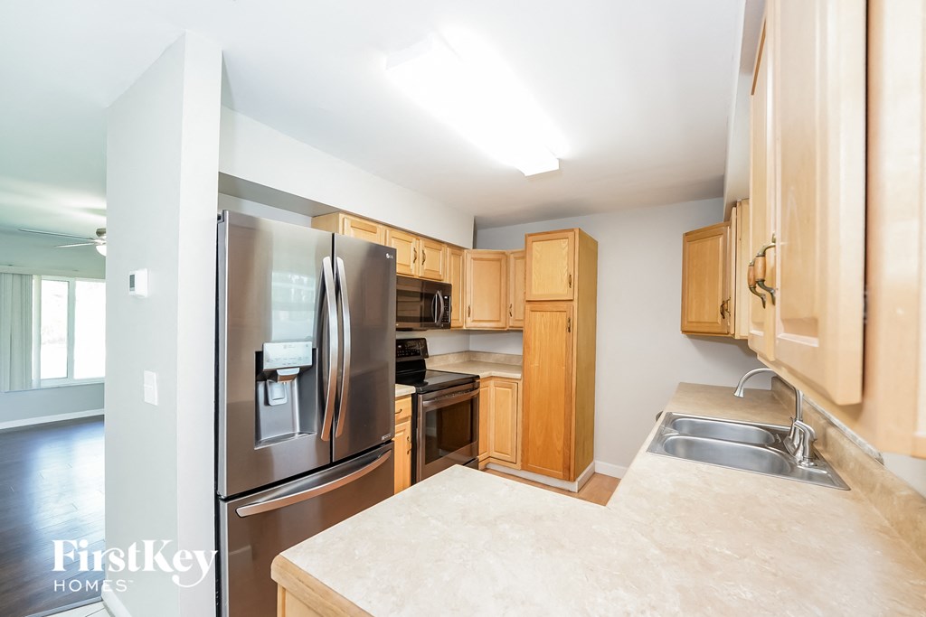 a kitchen with wooden cabinets and stainless steel appliances