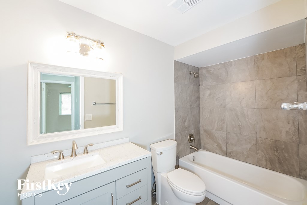a bathroom with a sink toilet and a bath tub