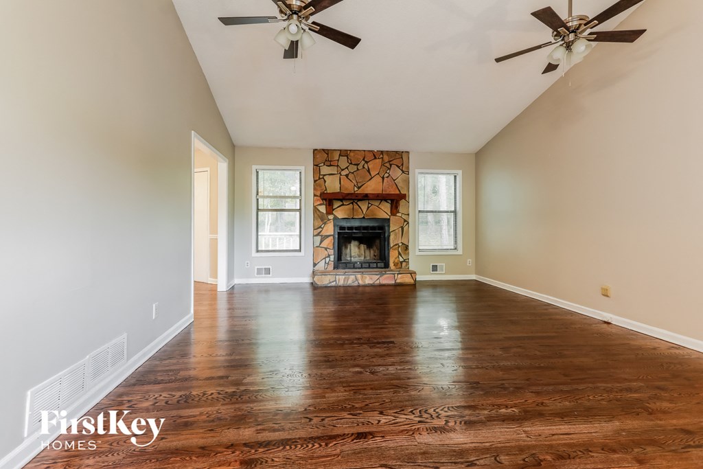 a living room with wood floors and a fireplace