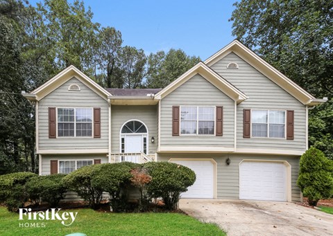 a house with two garage doors and a driveway