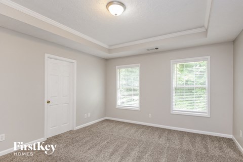 the upstairs bedroom has a door to the closet and a carpeted floor
