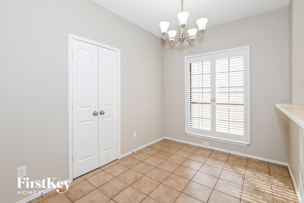 a dining room with a sink and a window and a door