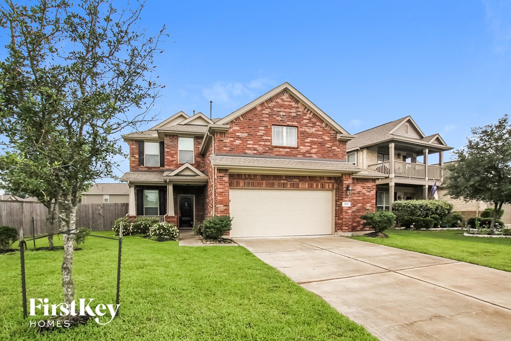 a red brick house with a white garage door