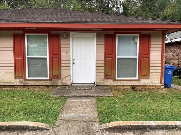 a small house with a white door and windows