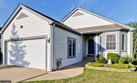 A two-story house with a white garage door.